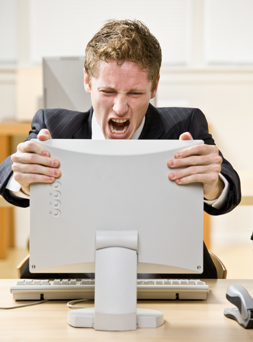 Businessman shouting at computer